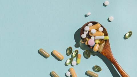 GNC Vitamin K supplement bottle with capsules supporting bone and heart health