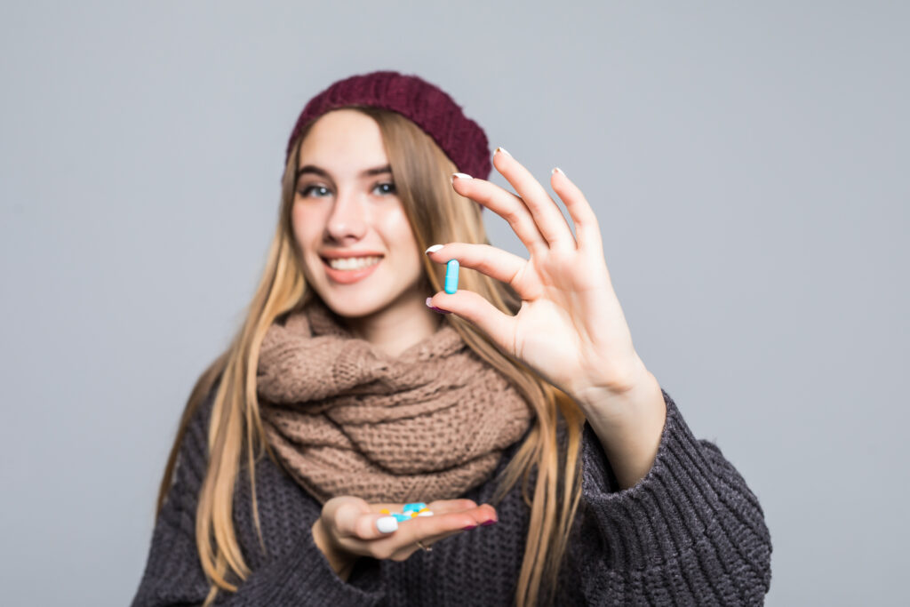 Woman holding multivitamin supplements for daily health and wellness in Pakistan