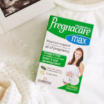 Box of Pregnacare Max prenatal vitamins by Vitabiotics on a white surface, with image of a smiling pregnant woman on the box.