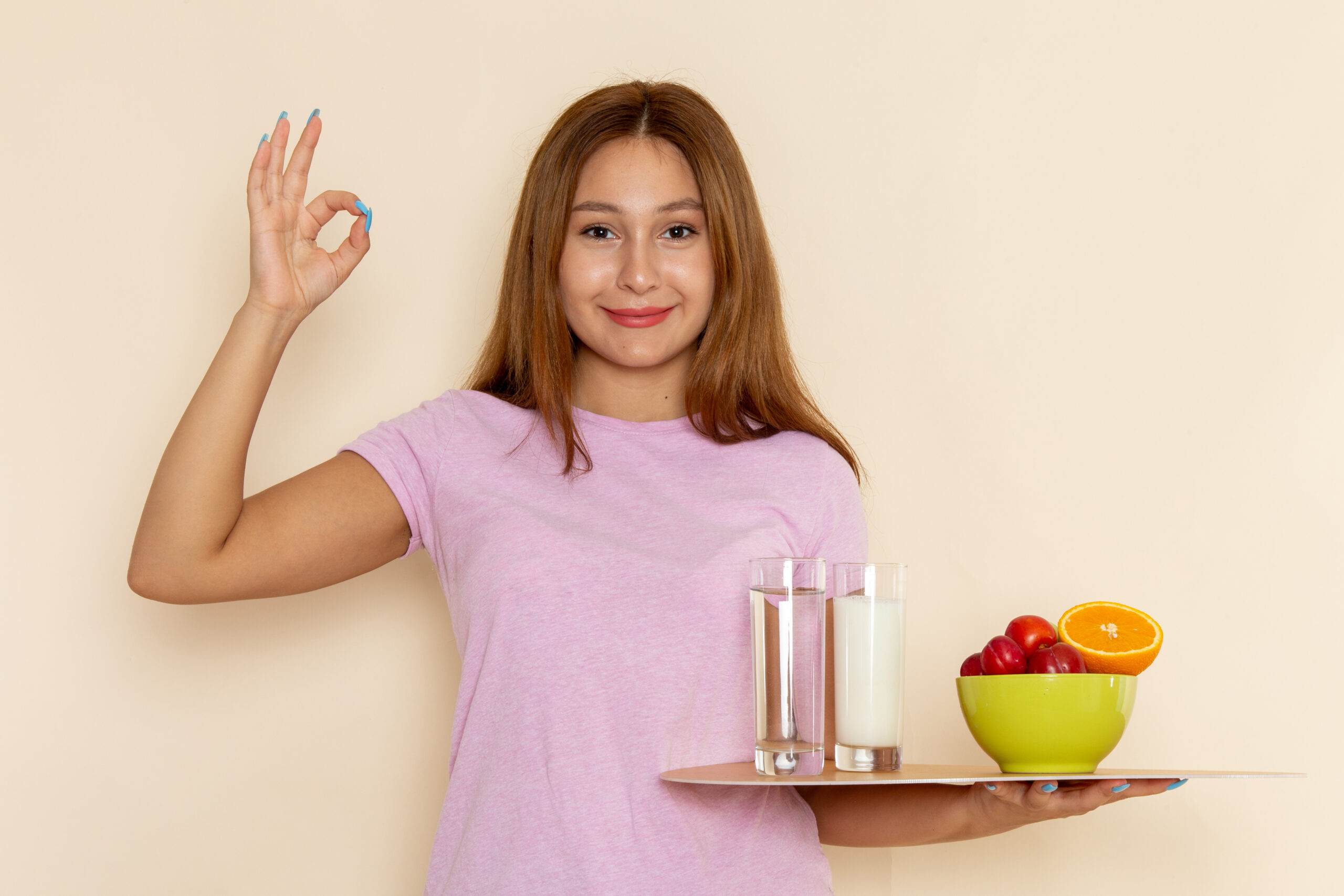 Woman taking One A Day multivitamin for daily health, energy, and wellness support.