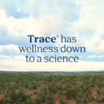 Slogan: 'Trace has wellness down to a science' over a wide prairie under a cloudy sky.